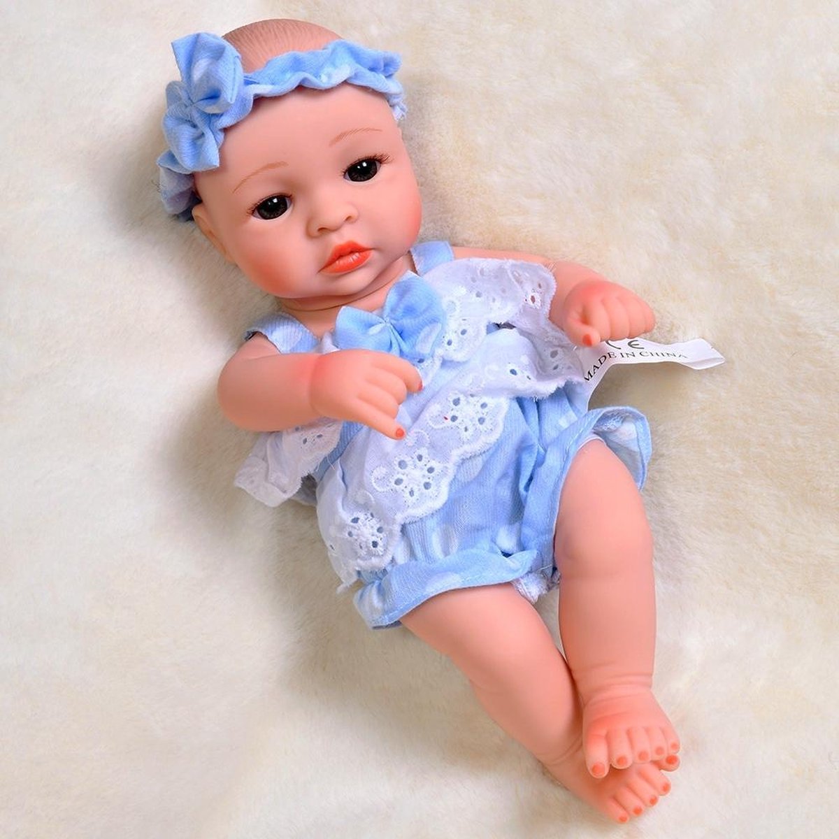 Kleine reborn baby pop 'Laura' - 30 centimeter - Blauw jurkje & haarband - Soft silicone - Waterproof - Ogen open