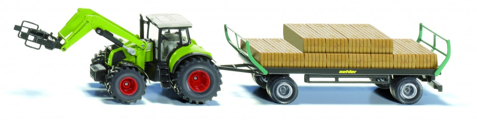 Claas Axion tractor met balengrijper en trailer (1946)